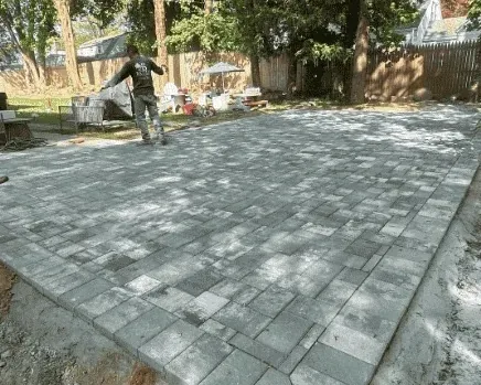 Finished paver patio with a soldier-course border laid by Baudi Landscaping in Westchester County, NY