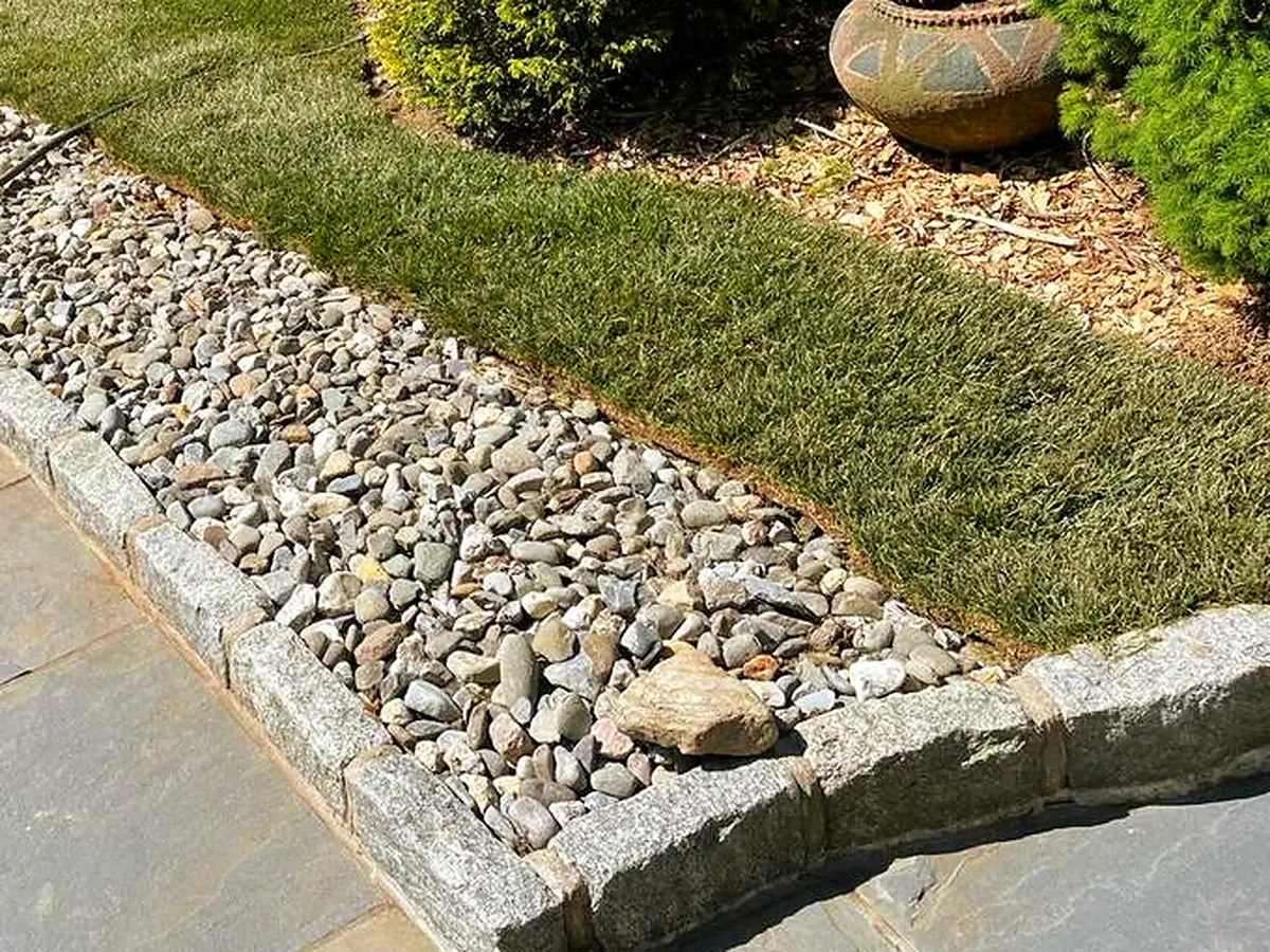 Bluestone patio with granite cobble edging and drainage rock