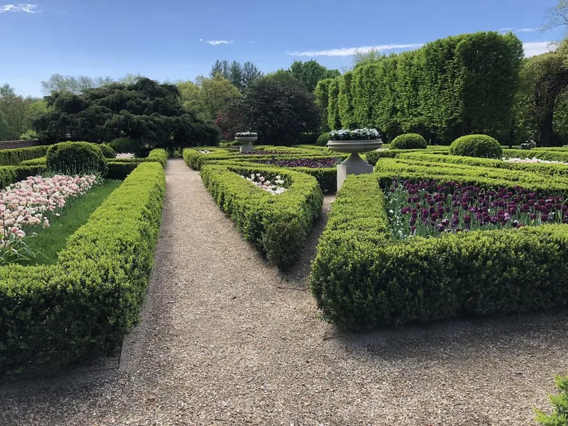 Formal boxwood parterre garden in bloom on an estate maintained by Baudi Landscaping